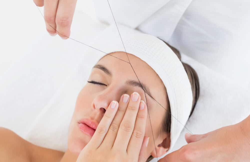 women eyebrow threading