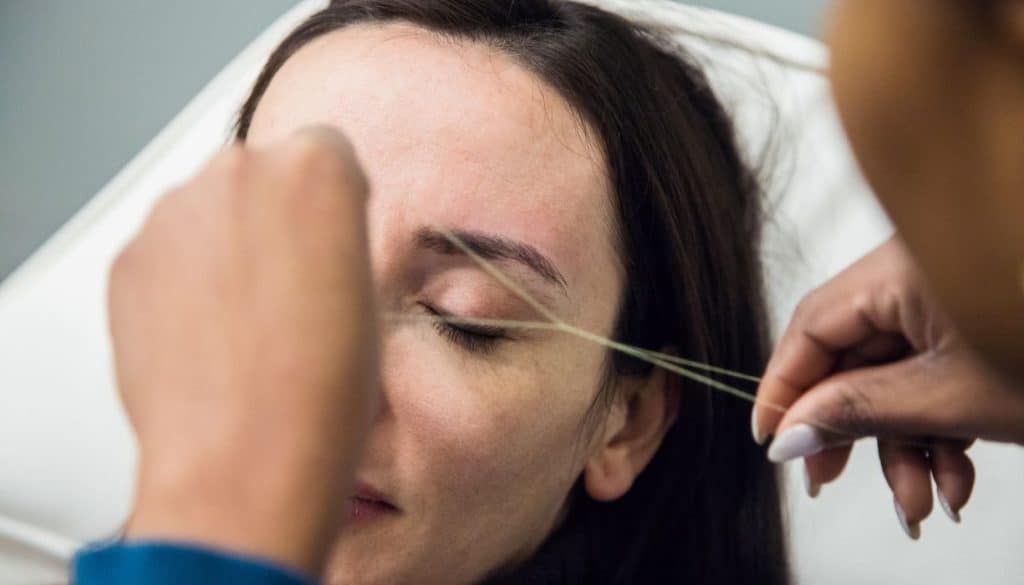 brow threading service at a salon