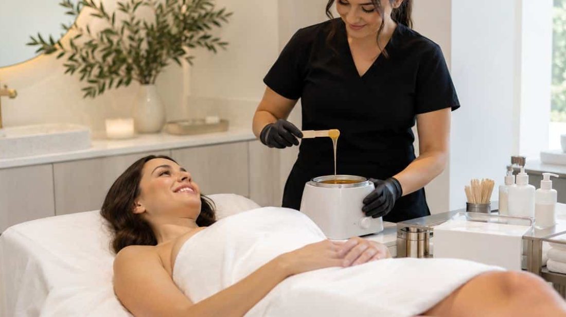 Relaxed client on a waxing table while the esthetician warms the wax