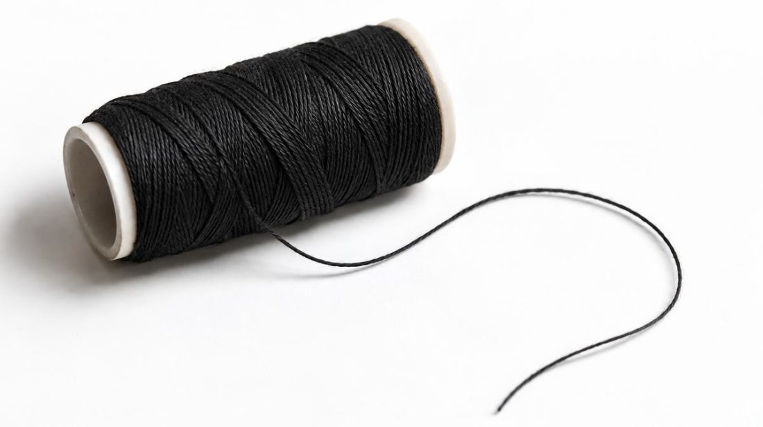Spool of cotton thread used for eyebrow threading