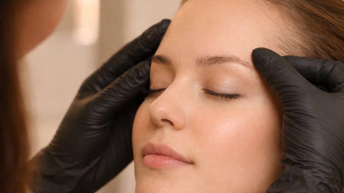 Professional eyebrow waxing and brow mapping at a salon showing quality brow shaping technique