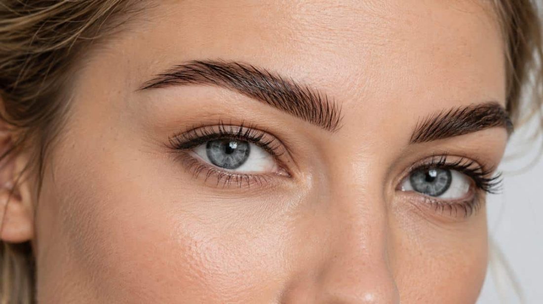 Close-up of defined, tinted brows