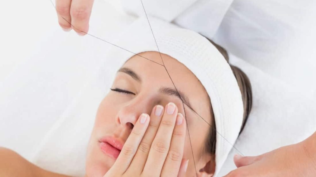 women eyebrow threading